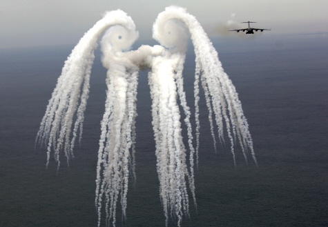 Photo of a smoke angel created by a jet flying through the smoke released by a flare